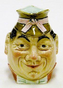 A Sarreguemines face jug No 7890 depicting a man with green hat and pink bow, p4a.com image by Deborah Dick.; - 85-01